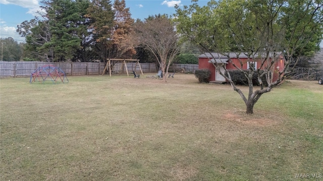 view of yard with a playground and a storage unit