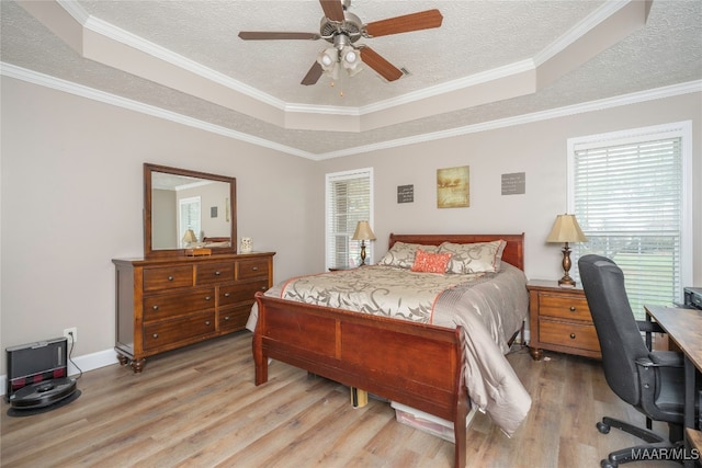 bedroom featuring light hardwood / wood-style floors, ceiling fan, and ornamental molding