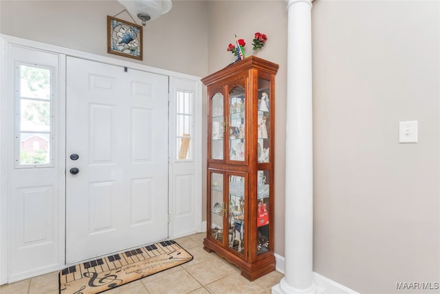 tiled foyer featuring decorative columns