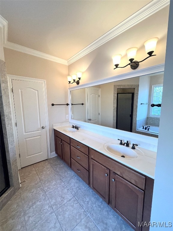 bathroom with a tub, vanity, tile patterned floors, and crown molding