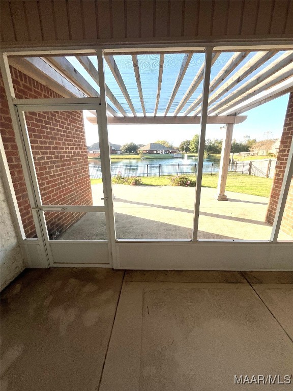 doorway to outside featuring a water view and plenty of natural light