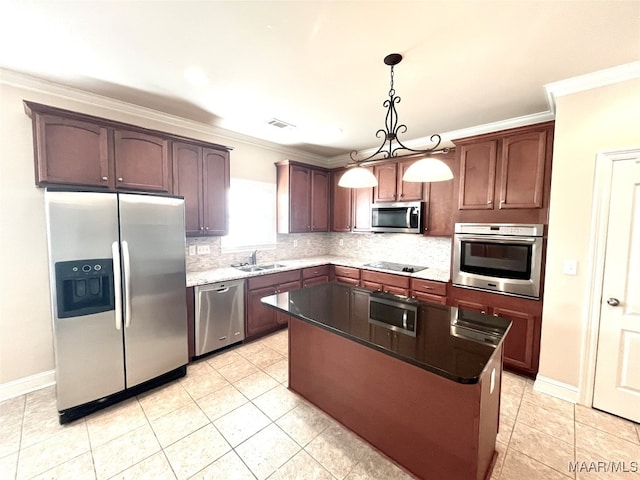 kitchen featuring a center island, sink, crown molding, pendant lighting, and appliances with stainless steel finishes