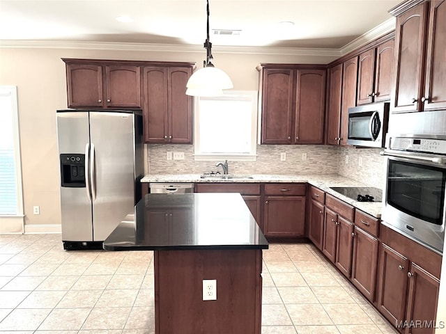 kitchen featuring stainless steel appliances, sink, light tile patterned floors, hanging light fixtures, and a kitchen island