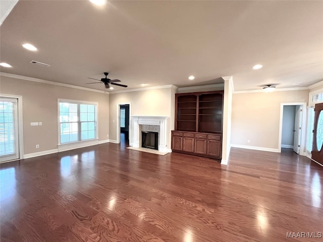 unfurnished living room featuring dark hardwood / wood-style floors, crown molding, and ceiling fan