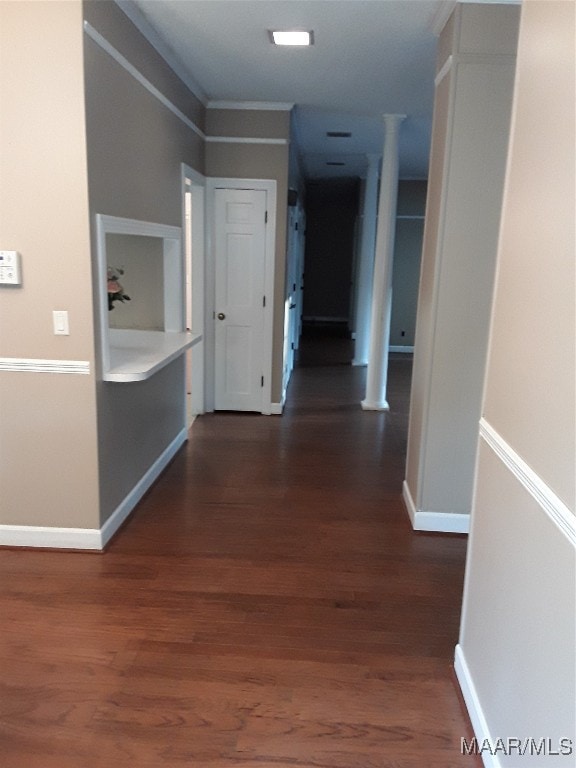 hallway featuring dark hardwood / wood-style flooring and crown molding