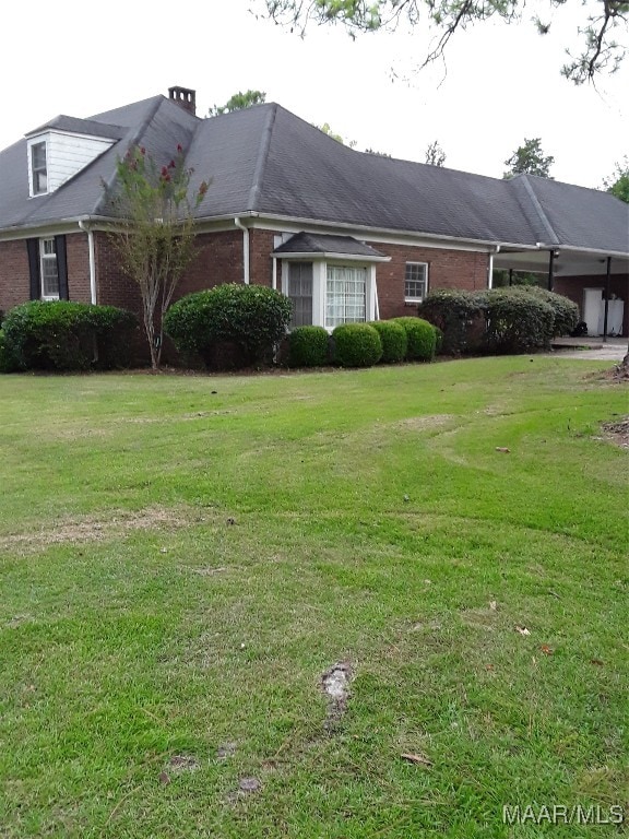 view of side of home featuring a lawn