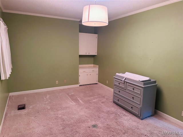 unfurnished bedroom with light colored carpet, a textured ceiling, and ornamental molding