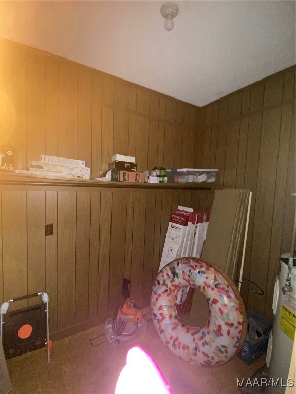 bedroom with water heater and wooden walls