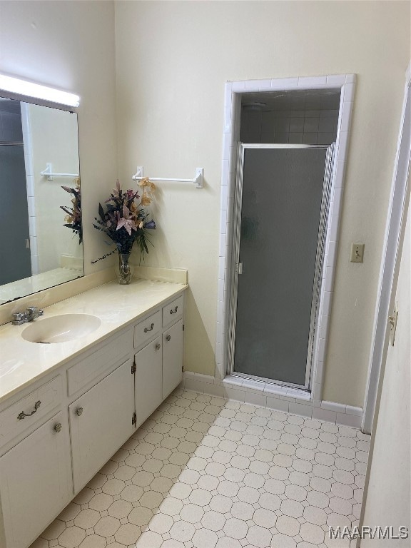 bathroom featuring vanity and a shower with door