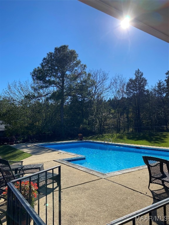 view of swimming pool with a patio area