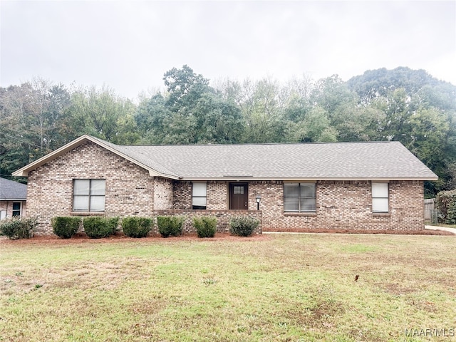 single story home featuring a front lawn