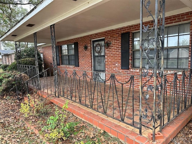 225 Merrimac Dr, Selma, AL 36701 - property entrance with a porch and brick siding