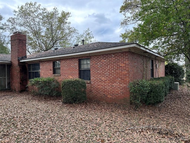 225 Merrimac Dr, Selma, AL 36701 - view of property exterior with a chimney, brick siding, and a shingled roof
