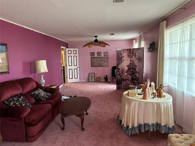 carpeted living room featuring ceiling fan and a textured ceiling