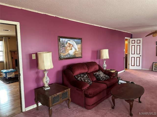 225 Merrimac Dr, Selma, AL 36701 - carpeted living area featuring a textured ceiling, ornamental molding, baseboards, and ceiling fan