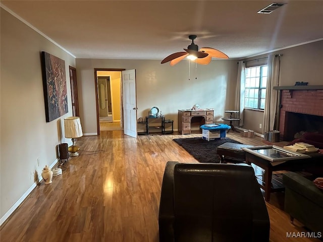 225 Merrimac Dr, Selma, AL 36701 - living room with ceiling fan, wood finished floors, baseboards, ornamental molding, and a fireplace