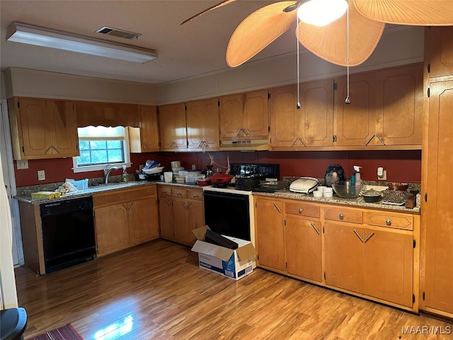 kitchen featuring exhaust hood, light hardwood / wood-style flooring, black appliances, and sink