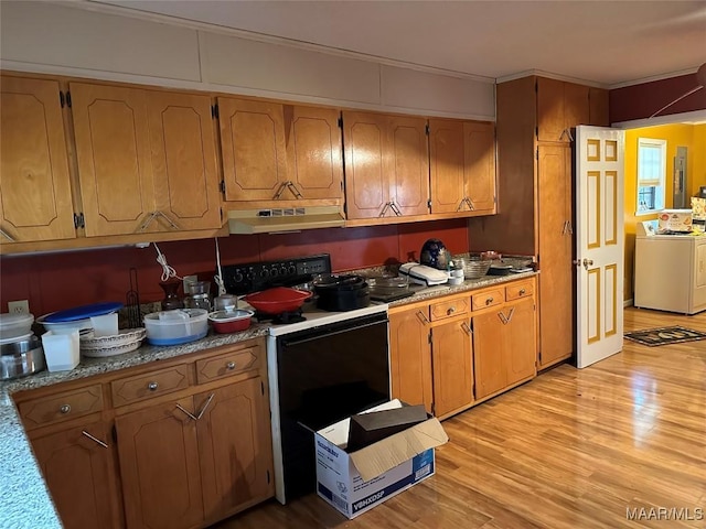 225 Merrimac Dr, Selma, AL 36701 - kitchen featuring range with electric cooktop, washer / clothes dryer, under cabinet range hood, light wood finished floors, and electric panel