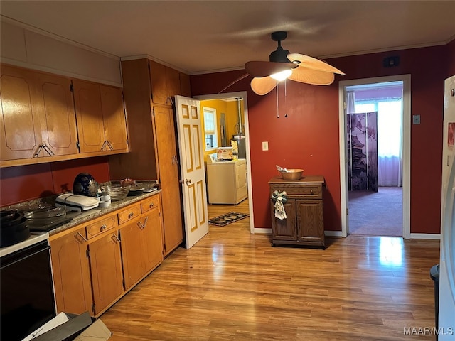 kitchen featuring light wood-type flooring, ceiling fan, and crown molding