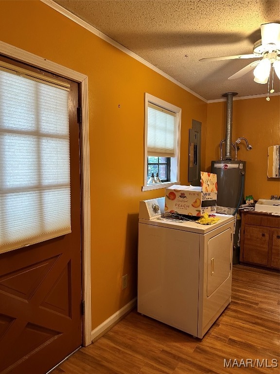 laundry area featuring electric panel, crown molding, ceiling fan, a textured ceiling, and wood-type flooring