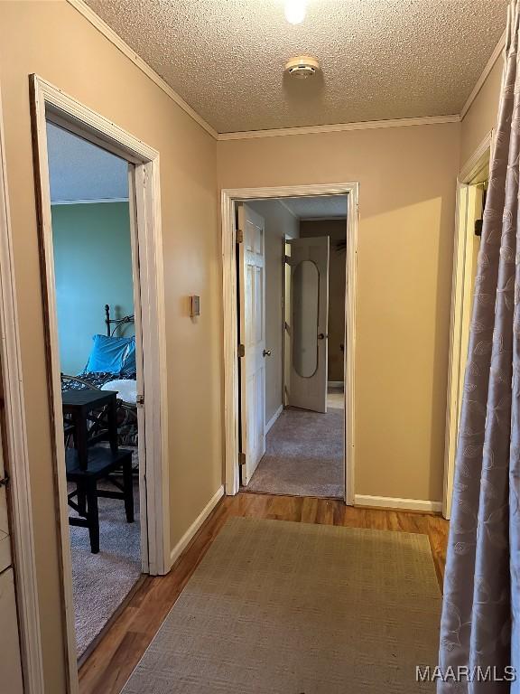 225 Merrimac Dr, Selma, AL 36701 - corridor with wood finished floors, crown molding, a textured ceiling, and baseboards