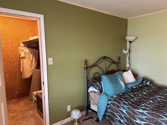 carpeted bedroom featuring ornamental molding and a textured ceiling