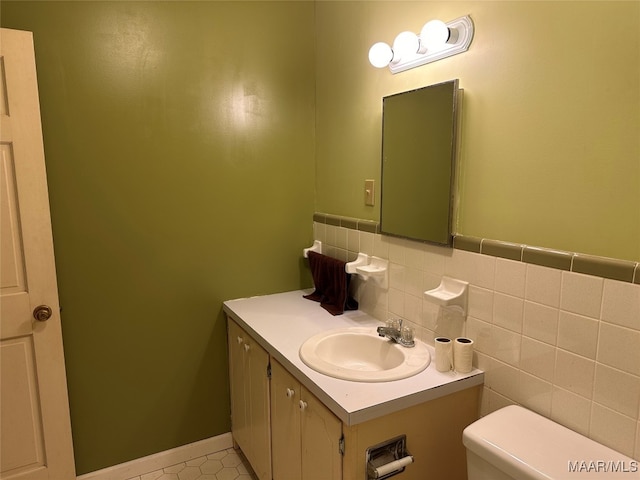 bathroom featuring tile patterned flooring, vanity, toilet, and tasteful backsplash