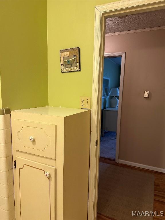 225 Merrimac Dr, Selma, AL 36701 - corridor with ornamental molding, a textured ceiling, wood finished floors, and baseboards