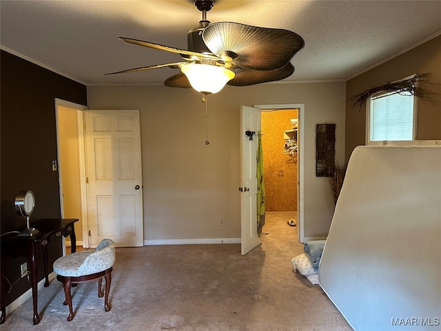 carpeted bedroom featuring crown molding, ceiling fan, and a textured ceiling