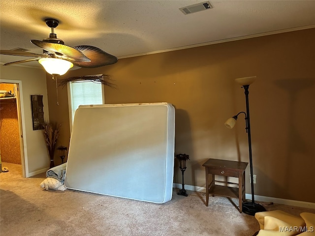 bedroom with light carpet, a textured ceiling, ceiling fan, and crown molding