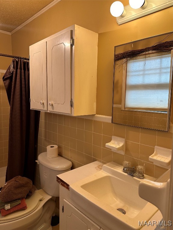 bathroom featuring a shower with shower curtain, vanity, toilet, and tile walls