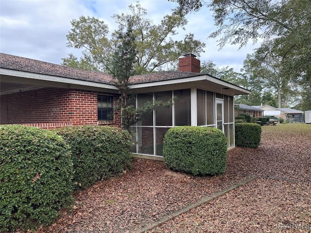 225 Merrimac Dr, Selma, AL 36701 - rear view of house featuring a chimney, a sunroom, and brick siding
