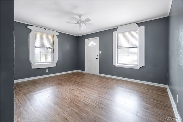 entryway featuring ceiling fan, hardwood / wood-style floors, and ornamental molding