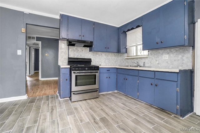 170 W S Blvd, Montgomery, AL 36105 - kitchen with stainless steel range with gas stovetop, under cabinet range hood, blue cabinets, and light wood-style floors