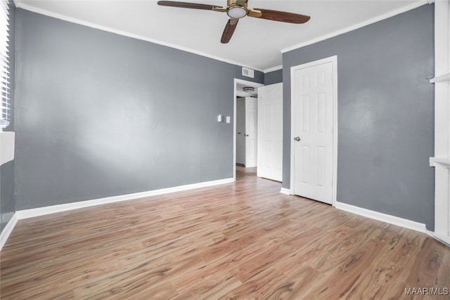 unfurnished bedroom with ornamental molding, light wood-type flooring, and ceiling fan