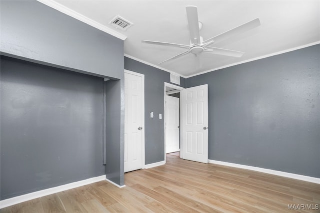 unfurnished bedroom featuring ornamental molding, light hardwood / wood-style flooring, and ceiling fan