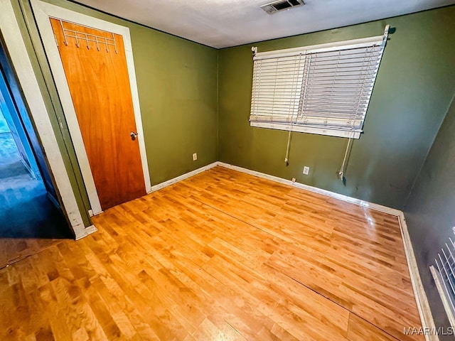 unfurnished bedroom with a closet and light wood-type flooring