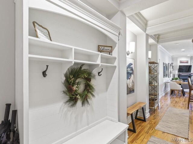 mudroom featuring ornamental molding and light hardwood / wood-style flooring