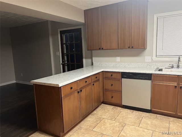 kitchen with kitchen peninsula, sink, and dishwasher