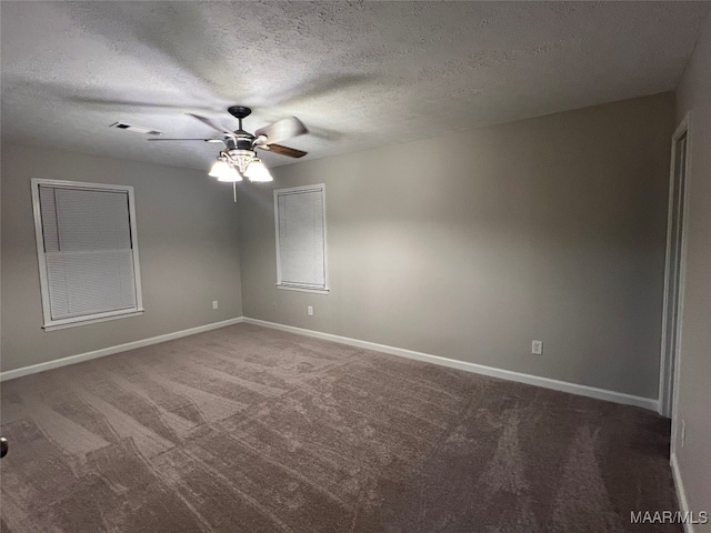 carpeted empty room featuring a textured ceiling and ceiling fan