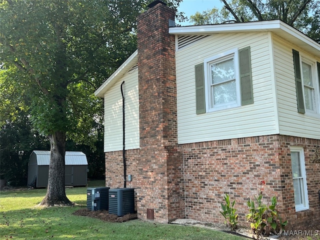 view of property exterior with central AC unit, a shed, and a lawn