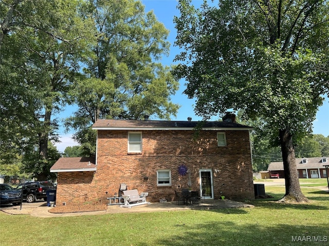 back of house featuring a patio and a lawn