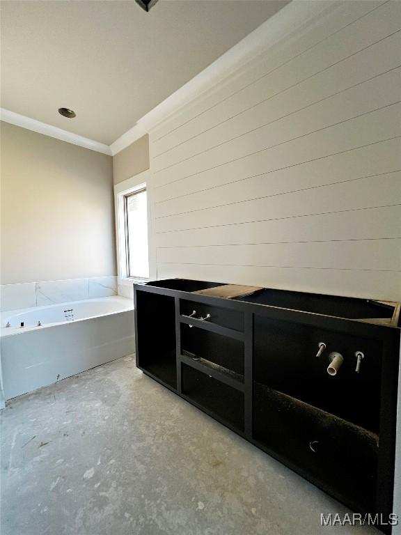 kitchen with ornamental molding and concrete floors