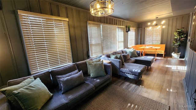 living room with hardwood / wood-style flooring and wooden walls