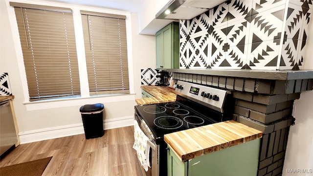 kitchen with light hardwood / wood-style floors, green cabinetry, and electric range