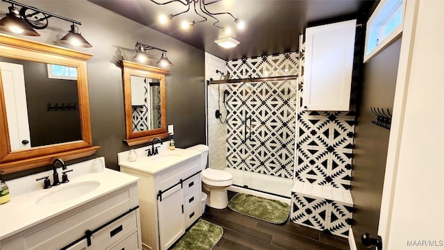 bathroom with a shower with door, vanity, toilet, and wood-type flooring