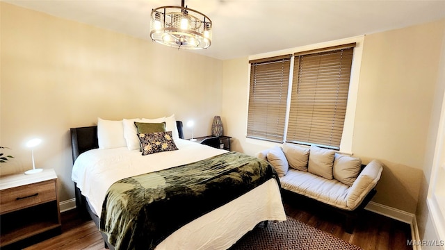 bedroom featuring dark hardwood / wood-style floors and a chandelier