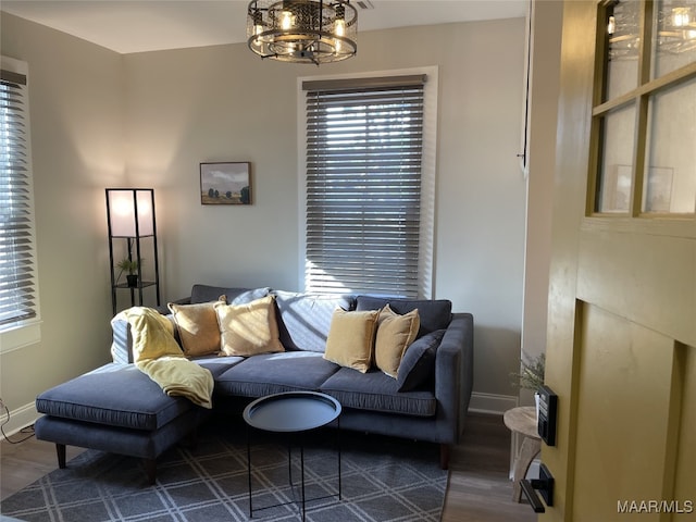 living room with an inviting chandelier and dark hardwood / wood-style flooring