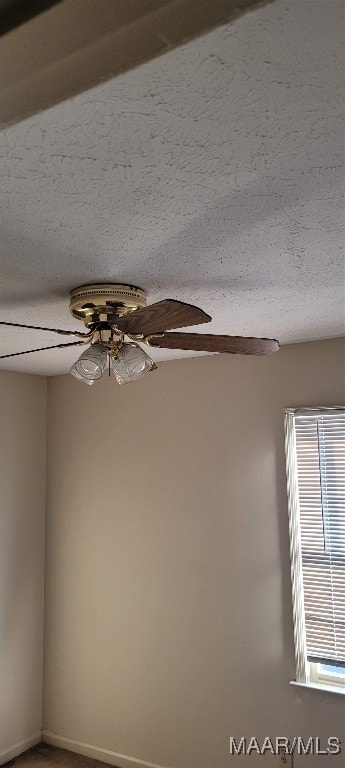 interior details featuring a textured ceiling and ceiling fan