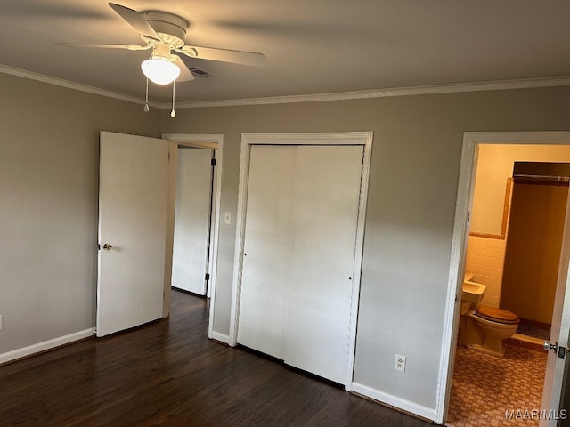 unfurnished bedroom featuring dark wood-type flooring, ceiling fan, ensuite bath, and ornamental molding